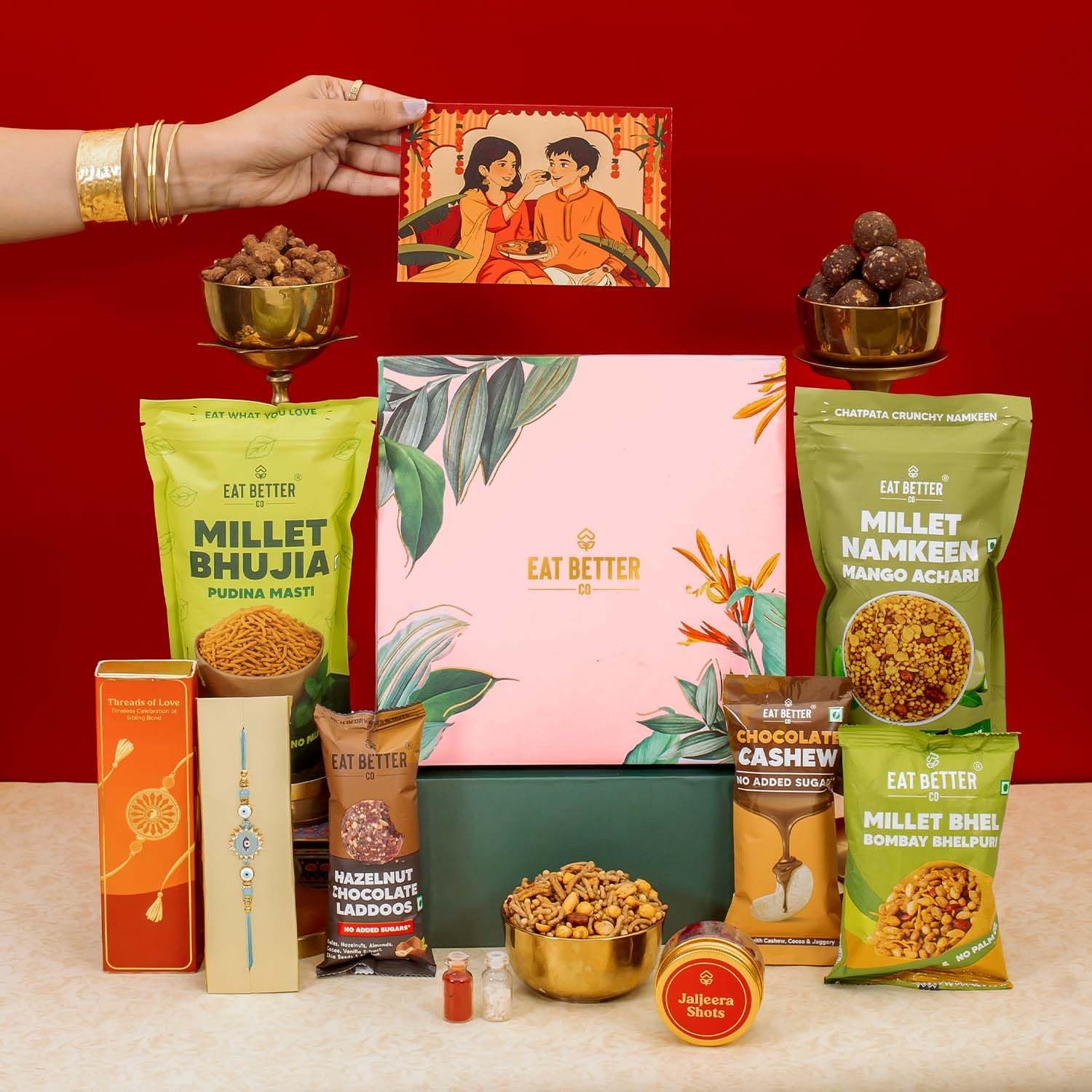 Eat Better Co Classic - 9 item Rakhi Gift Hamper for Brother - Premium Evil Eye Rakhi with Roli Chawal, Hazelnut Chocolate Dy-Fruit Laddu, Chocolate Cashews, Millet Bhujia, Namken, Bhel & more